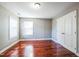 Cozy bedroom with hardwood floors, two windows, and a closet at 309 Malvern Hill Ln, Morrisville, NC 27560