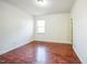Bright bedroom with a window and hardwood floors at 309 Malvern Hill Ln, Morrisville, NC 27560