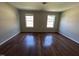 Bright bedroom boasts hardwood floors, light walls, and ample natural light at 309 Malvern Hill Ln, Morrisville, NC 27560