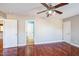 Large bedroom with hardwood floors, a ceiling fan, and multiple doorways at 309 Malvern Hill Ln, Morrisville, NC 27560