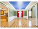 Elegant dining room boasts hardwood floors, wainscoting, a tray ceiling, and decorative chandelier at 309 Malvern Hill Ln, Morrisville, NC 27560