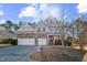 Charming two-story home featuring a stone facade, attached two-car garage, and beautifully maintained landscaping at 309 Malvern Hill Ln, Morrisville, NC 27560