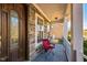 Inviting front porch featuring stone accents, decorative door, and cozy seating area at 309 Malvern Hill Ln, Morrisville, NC 27560