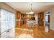 Bright kitchen with wood cabinets, an island, stainless appliances, and a sliding glass door at 309 Malvern Hill Ln, Morrisville, NC 27560