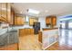 Spacious kitchen features stainless steel appliances, granite countertops, island, and view to the dining area at 309 Malvern Hill Ln, Morrisville, NC 27560