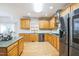 This kitchen features stainless steel appliances, granite countertops, light wood cabinetry, and tile backsplash at 309 Malvern Hill Ln, Morrisville, NC 27560