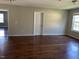 Large living space with hardwood floors, light walls, and multiple entrances at 309 Malvern Hill Ln, Morrisville, NC 27560