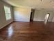 Well-lit open living space with hardwood floors, light walls, and large window at 309 Malvern Hill Ln, Morrisville, NC 27560