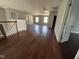 Open living room with hardwood floors, neutral paint, and abundant natural light from the windows at 309 Malvern Hill Ln, Morrisville, NC 27560