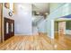 Spacious living room featuring hardwood floors, staircase, and large windows at 309 Malvern Hill Ln, Morrisville, NC 27560