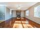 Spacious living room with hardwood floors, a stone fireplace, and lots of natural light at 309 Malvern Hill Ln, Morrisville, NC 27560