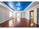 Large primary bedroom with a blue accent ceiling, and hardwood floors at 309 Malvern Hill Ln, Morrisville, NC 27560