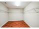 Empty walk-in closet with hardwood floors and wire shelving at 309 Malvern Hill Ln, Morrisville, NC 27560