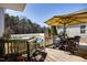 Back deck featuring a hot tub, outdoor seating, and patio umbrella at 3337 Scarlet Oak Dr, Mebane, NC 27302