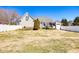 Wide backyard featuring a patio with a hot tub and white vinyl privacy fence at 3337 Scarlet Oak Dr, Mebane, NC 27302
