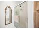 Bathroom features a glass-enclosed shower, decorative mirror, and neutral-toned walls at 3337 Scarlet Oak Dr, Mebane, NC 27302