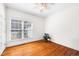Bright bedroom featuring hardwood floors, white walls, and a large window at 3337 Scarlet Oak Dr, Mebane, NC 27302