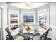 This breakfast nook features large windows with a glass-topped table and ornate metal chairs at 3337 Scarlet Oak Dr, Mebane, NC 27302