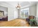 Bright dining room features hardwood floors, a chandelier, and a large window for ample natural light at 3337 Scarlet Oak Dr, Mebane, NC 27302