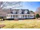Charming two-story home with a large front porch and a well-manicured lawn at 3337 Scarlet Oak Dr, Mebane, NC 27302