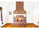 Close-up of a striking brick fireplace with a traditional mantel and cozy fire at 3337 Scarlet Oak Dr, Mebane, NC 27302