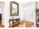 Bright foyer featuring hardwood floors and a decorative mirror and table at 3337 Scarlet Oak Dr, Mebane, NC 27302