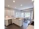 A kitchen with stainless steel appliances and views to the breakfast nook with black tile flooring at 3337 Scarlet Oak Dr, Mebane, NC 27302