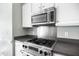 The kitchen boasts stainless steel appliances and white cabinets with an oven and gas stovetop at 3337 Scarlet Oak Dr, Mebane, NC 27302