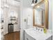 Elegant bathroom with marble vanity, gold framed mirror, and mini beverage cooler at 3343 Ridgecrest Ct, Raleigh, NC 27607