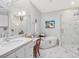 Bright bathroom featuring a soaking tub, marble countertops, and a glass-enclosed shower at 3343 Ridgecrest Ct, Raleigh, NC 27607
