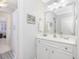 Bathroom featuring white cabinets, a large mirror, and a view into the shower area at 3343 Ridgecrest Ct, Raleigh, NC 27607