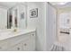 Bright bathroom featuring white cabinets, a large mirror, and a shower with a curtain at 3343 Ridgecrest Ct, Raleigh, NC 27607