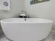 Close up view of soaking tub with marble floors in bright bathroom at 3343 Ridgecrest Ct, Raleigh, NC 27607