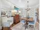 Elegant dining room with vintage furniture, unique wallpaper, and a decorative chandelier at 3343 Ridgecrest Ct, Raleigh, NC 27607