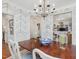 Traditional dining room featuring a wood table, chandelier, and stylish patterned wallpaper at 3343 Ridgecrest Ct, Raleigh, NC 27607