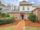 Charming two-story home with brick facade, dormer windows, and mature landscaping at 3343 Ridgecrest Ct, Raleigh, NC 27607