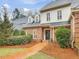 Charming brick and stucco home with a well-manicured front yard and inviting brick walkway at 3343 Ridgecrest Ct, Raleigh, NC 27607