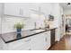 Bright kitchen with white cabinets, subway tile backsplash, and sleek black countertops at 3343 Ridgecrest Ct, Raleigh, NC 27607