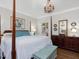Elegant main bedroom with a four-poster bed, classic furnishings, and ample natural light at 3343 Ridgecrest Ct, Raleigh, NC 27607