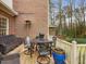 Outdoor patio featuring a seating area, dining table, grill, and wooded view at 3343 Ridgecrest Ct, Raleigh, NC 27607