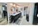 Well-lit bathroom with double sinks, vanity, and a stylish tile floor at 3441 S Beaver Ln, Raleigh, NC 27604