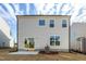 Backyard view features the home's exterior, windows, and small concrete patio at 3505 Triad Ct, Raleigh, NC 27604