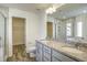 Bathroom featuring double vanity with granite counters and walk-in closet at 3505 Triad Ct, Raleigh, NC 27604