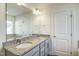 Bright bathroom featuring a granite countertop vanity and a large mirror at 3505 Triad Ct, Raleigh, NC 27604