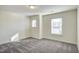 Carpeted bedroom featuring two windows, offering ample natural light and ventilation at 3505 Triad Ct, Raleigh, NC 27604