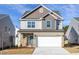 Charming two-story home featuring a brick facade, attached garage, and welcoming curb appeal at 3505 Triad Ct, Raleigh, NC 27604