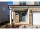 Inviting front porch and door with brick facade detailing and manicured landscaping at 3505 Triad Ct, Raleigh, NC 27604