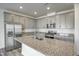 Modern kitchen with granite counters, stainless steel appliances, and gray cabinets at 3505 Triad Ct, Raleigh, NC 27604