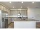 Bright kitchen with stainless steel appliances, granite countertops, and gray cabinets at 3505 Triad Ct, Raleigh, NC 27604