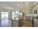 Bright kitchen with granite island, stainless appliances, and wood-look floors at 3505 Triad Ct, Raleigh, NC 27604